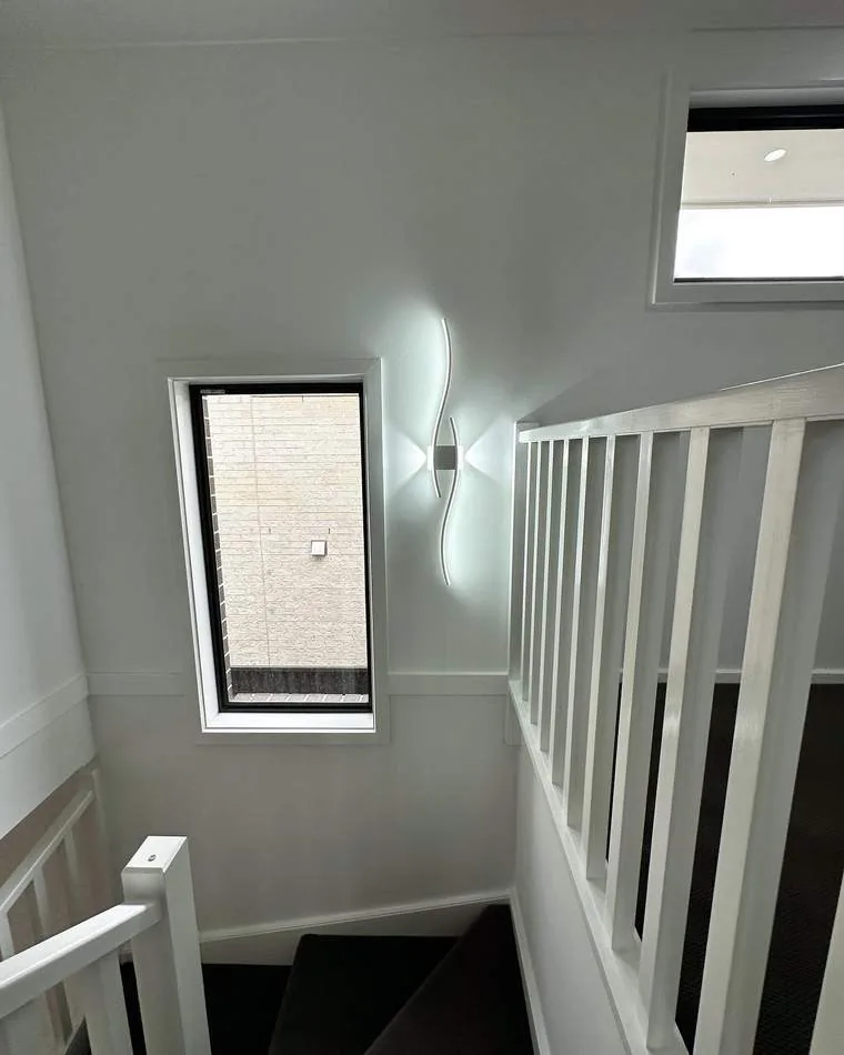 Modern stairwell with decorative wall light and clean interior finish